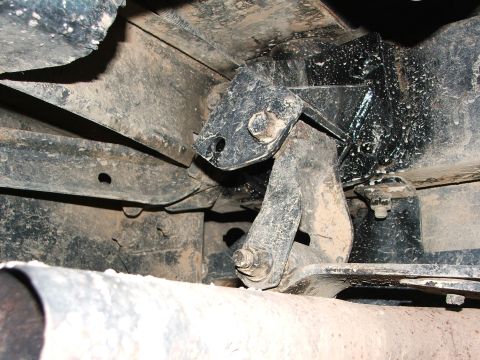 1996 Ford Bronco - Undercarriage view of a vehicle's suspension or exhaust mounting bracket.