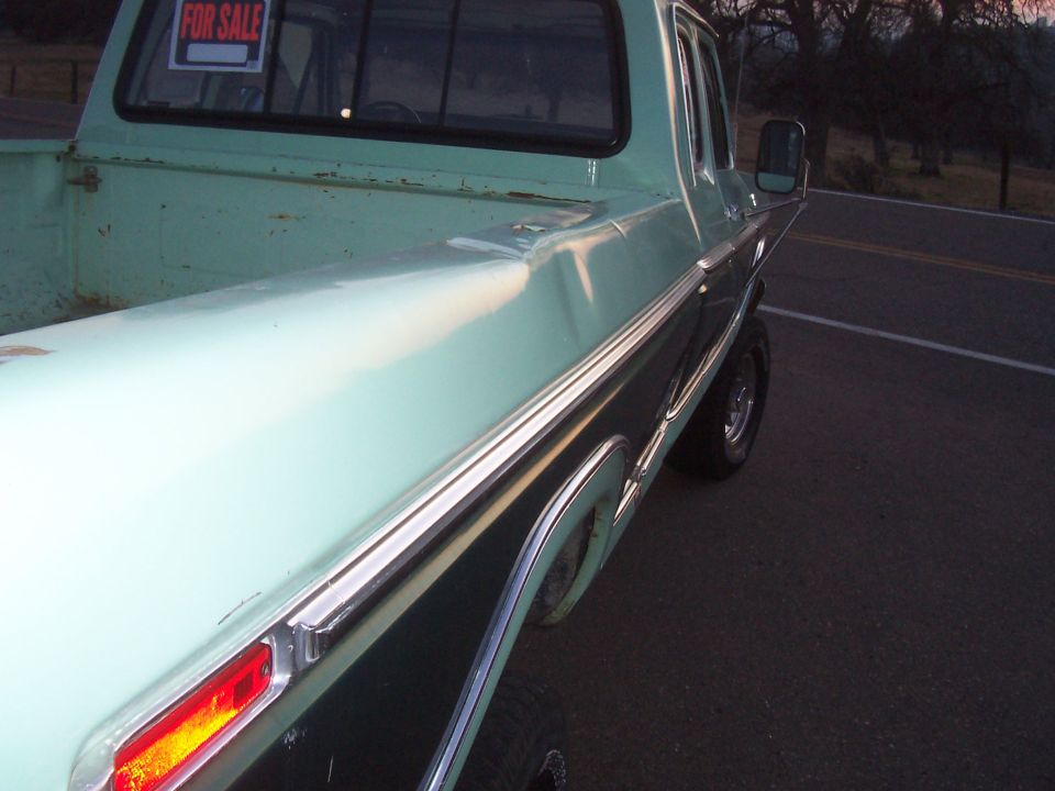 right side view from rear. Notice dents on bed rail