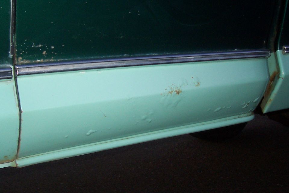rust bubbles in paint on lower section of left side of extended cab