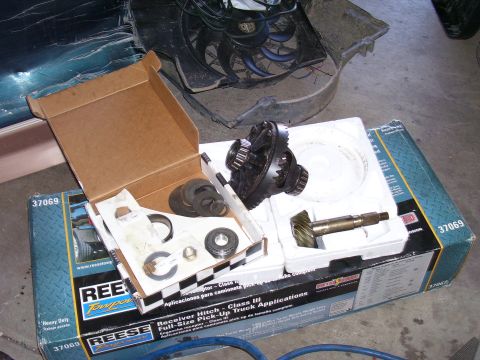 1991 Ford Bronco - Parts for a vehicle differential are laid out in boxes, including gears and bearings.