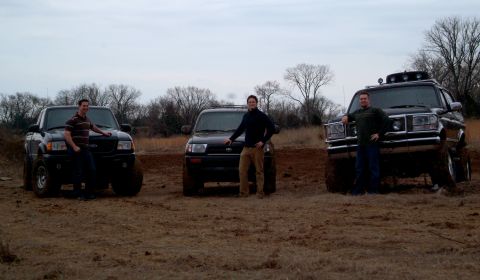 1995 Ford Bronco - Group shot in a muddy field with three people each standing beside their rig: a dark Ford Ranger pickup on the left, a lifted Toyota 4Runne…