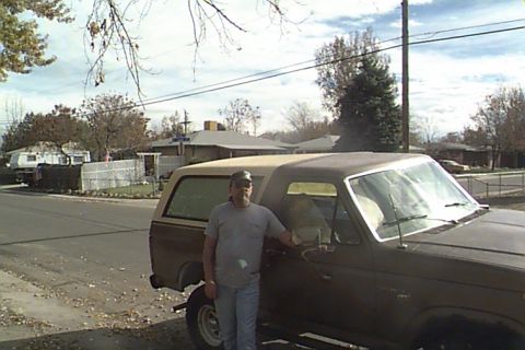 1980 Ford Bronco - A man stands beside a brown Ford Bronco, which appears to be from the late 1970s.