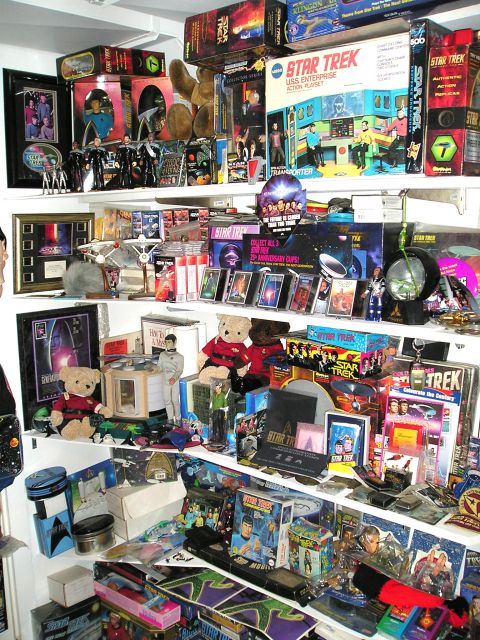 1966 Pontiac Fiero - A vast collection of Star Trek merchandise fills multiple shelves, various toys and memorabilia.