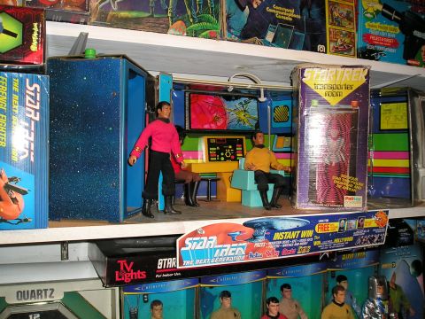 1966 Pontiac Fiero - A Star Trek transporter room playset is displayed on a shelf with various Star Trek merchandise.