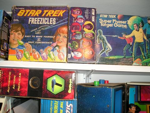 1966 Pontiac Fiero - A collection of vintage Star Trek merchandise is displayed on shelves, including games and toys.