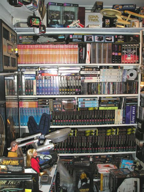 1966 Pontiac Fiero - A collection of Star Trek memorabilia, including models, DVDs, and books, is displayed on shelves.