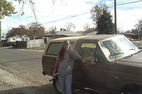 1980 Ford Bronco - A man stands next to a brown 1980 Ford Bronco, captured from a 3/4 front angle.