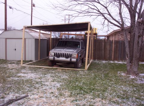 1987 Jeep Cherokee - This 1987 Jeep Cherokee is parked under a temporary shelter in a yard with light snow on the ground.
