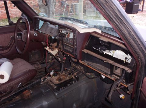 1987 Jeep Cherokee - The interior of a Jeep Cherokee shows exposed wiring and components beneath the dashboard.