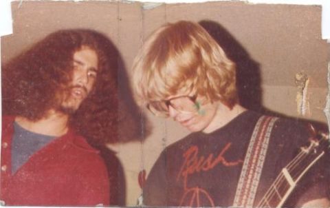 1990 Ford Bronco - Two men, one with long hair and a red jacket, the other with blond hair and glasses, pose for a photo.