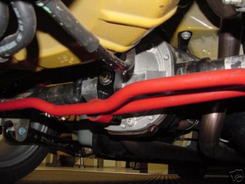 2007 Saleen S-302 - Undercarriage view showing the rear axle assembly and bright red sway bars on a yellow vehicle.