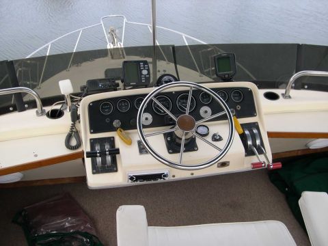 1982 Ford Bronco - The helm of a boat shows navigation equipment and controls.