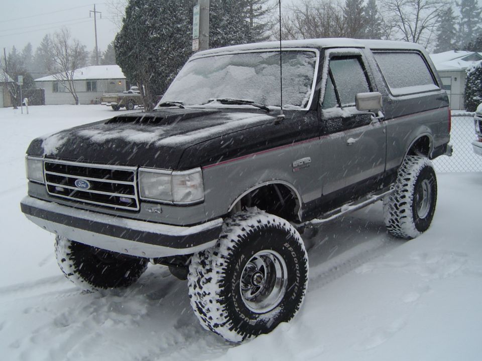 Lifted black and gray Ford Bronco in the snow