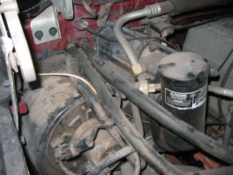1991 Ford Bronco - Close-up view of engine bay components including AC lines and receiver-drier.