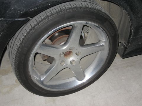 1986 Ford Bronco - A close-up view of a five-spoke alloy wheel and tire, with the SuperMotors.net logo visible in the lower right corner.