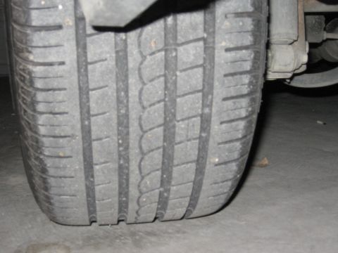 1986 Ford Bronco - The image shows a close-up view of a tire's tread pattern.