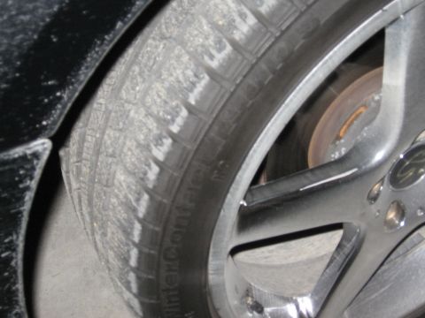 1986 Ford Bronco - A close-up view of a vehicle's tire and wheel assembly, showing tread detail and alloy rim.