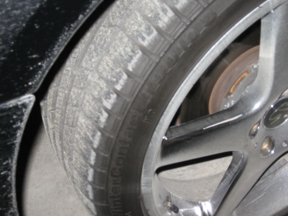 Close-up of a car tire with 'WinterContact' text and a chrome alloy wheel