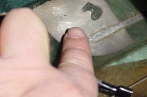 1996 Ford Bronco - The area where the tab attaches to the window is lightly sanded to prepare it for epoxying the tab. Take care not to sand through to glass.
