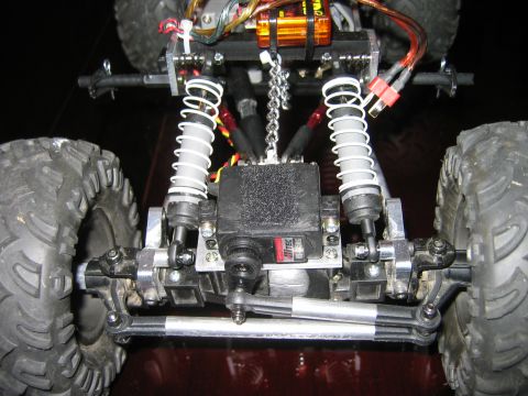 1985 Ford Bronco - Close-up view of the front suspension and steering components of a remote-controlled vehicle.