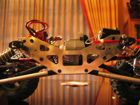 1985 Ford Bronco - Close-up view of an RC car's chassis, its suspension components and electrical wiring.