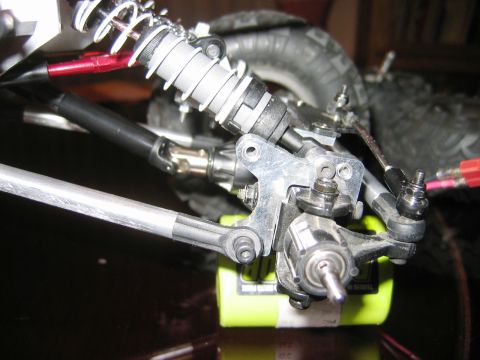1985 Ford Bronco - Detail of RC truck suspension components, including shock, linkage, and drive shaft.