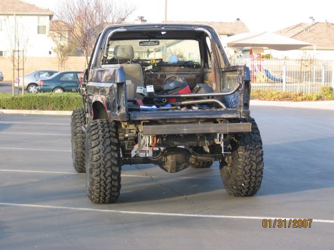 1994 Ford Bronco - This heavily modified SUV has a custom rear bumper and roll cage, with its rear body panels removed.