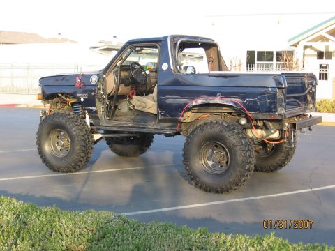 1994 Ford Bronco - This modified 1994 Ford Bronco features large off-road tires and a lifted suspension, with its doors removed.