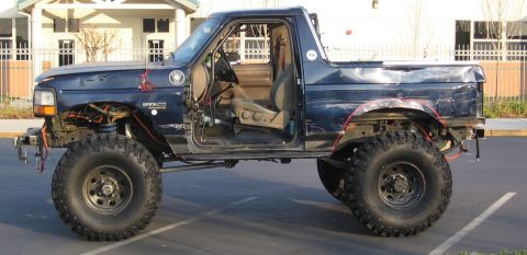 1994 Ford Bronco - This modified Ford Bronco has its doors removed and features a lifted suspension with large tires.