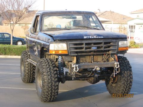 1994 Ford Bronco - This lifted Ford Bronco has a custom front bumper and large off-road tires.