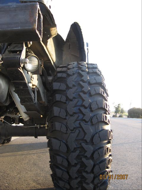 1994 Ford Bronco - A close-up view focuses on the aggressive tread of an off-road tire and the vehicle's suspension components, dated January 31, 2007.