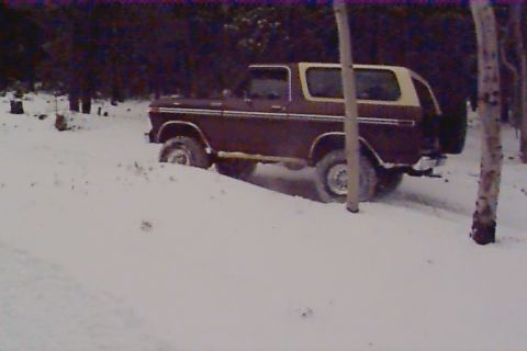 1980 Ford Bronco - Ford Bronco navigating a snowy terrain during winter.