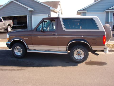 1993 Ford Bronco - Side profile of a 1993 Ford Bronco parked in a driveway.