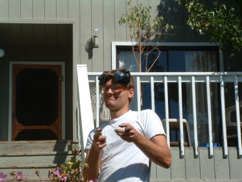 1999 Jeep Grand Cherokee - A man stands on a wooden porch, wearing protective eyewear and pointing at the camera.