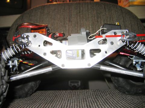 1985 Ford Bronco - Close-up of a remote control truck's chassis, showing suspension and electronic components.