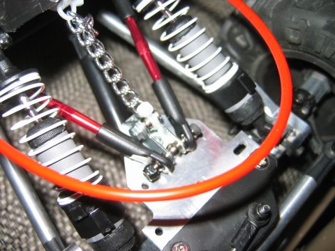 1985 Ford Bronco - Detail view of suspension parts on a remote control truck, including shocks and springs.