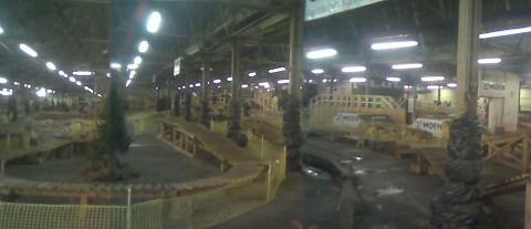 1997 Ford Probe - An indoor dirt track facility with ramps and wooden obstacles, a Supermotors.net logo in the corner.