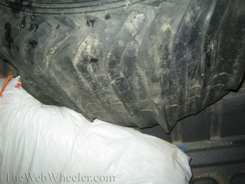 Paddle tires loaded in truck bed next to white bags