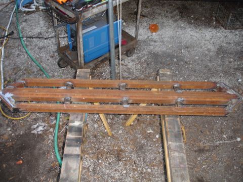 1989 Ford Bronco - Custom metal sliders are shown resting on sawhorses, with welding equipment visible in the background.