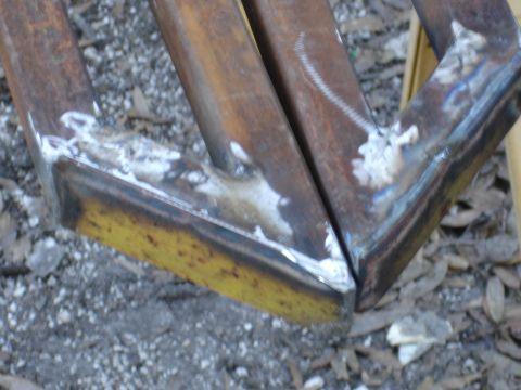 1989 Ford Bronco - Close-up of custom metal sliders, showing welding and wear.