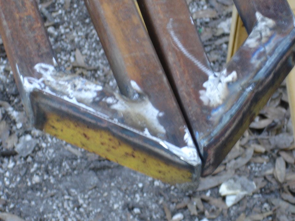 Welded metal sliders with yellow undercoating and rust