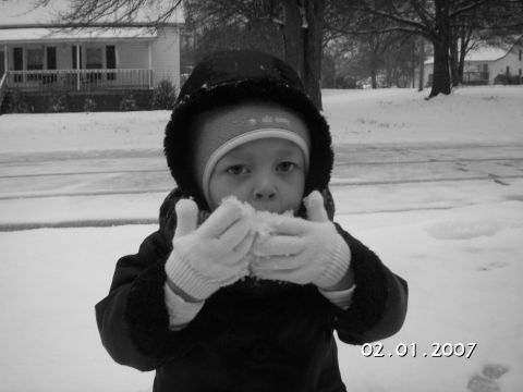 1996 Ford Bronco - A child enjoys a snowy day by eating snow, with a house visible in the background.