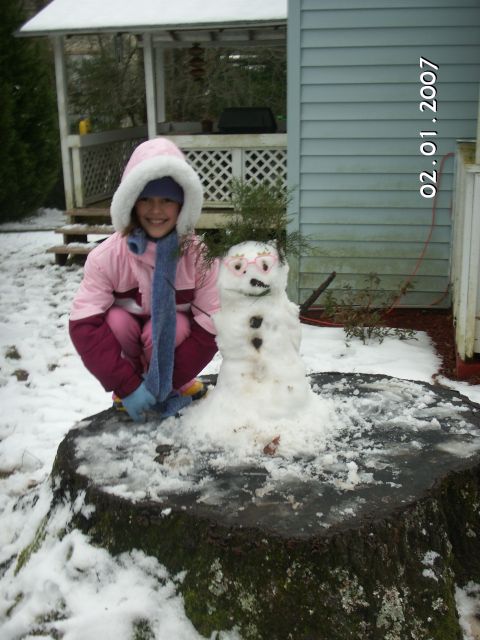 1996 Ford Bronco - A young girl and her snowman enjoy a snowy day outdoors.