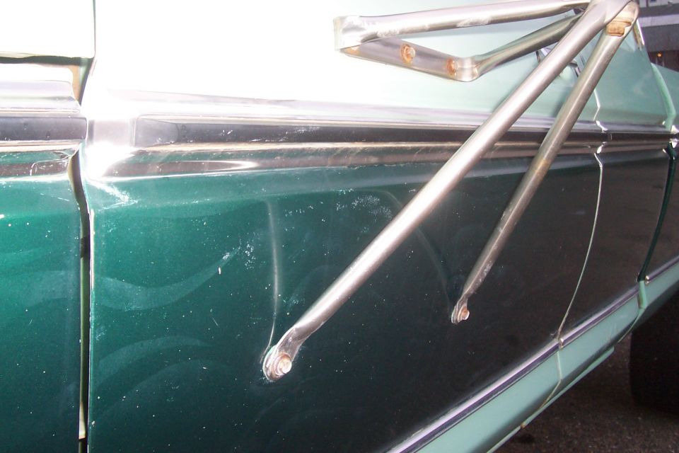 left side door. If you look closley you can see faint flames on the door. These were badly faded out and discolored, so they were removed with acetone.