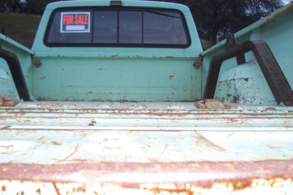 Pickup bed and rear cab window with a FOR SALE sign