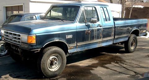 1988 Ford F-250 - This 1988 Ford F-250 pickup truck is parked in front of a garage.