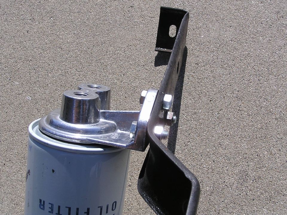 Spin-on oil filter mounted on a fabricated metal bracket