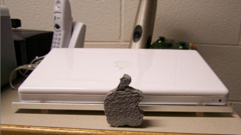 1999 Ford Taurus - A small statue sits before a white Apple laptop, with household items visible in the background.