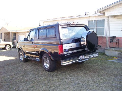 1995 Ford Bronco - Rear view of a 1995 Ford Bronco with a spare tire mounted on the back.