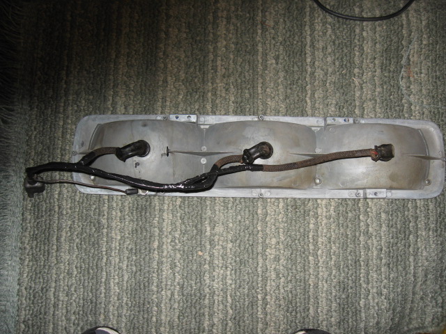 Back of a three-lens car tail light assembly with wiring